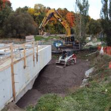Skit-steer Backfilling surrounding tanks