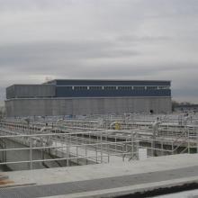 Tank Cells and guardrails with distant building in background