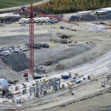 Tower crane over site where concrete pour for base slab is taking place
