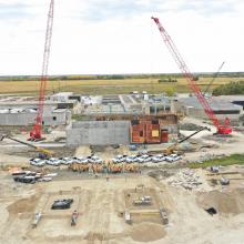 Aerial overview of jobsite with NAC team standing between two large cranes