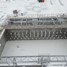 winter photo of empty tank with multiple pipe penetrations entering tank