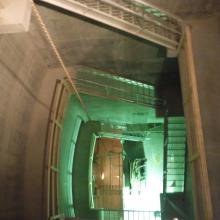 View looking down into deep stairwell leading into basement