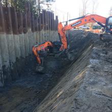 excavation being completed next to shoring