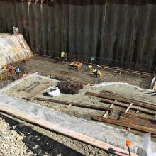 Rebar installation within excavation for base slab