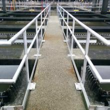 walkway with guardrail containing sedimentation tanks